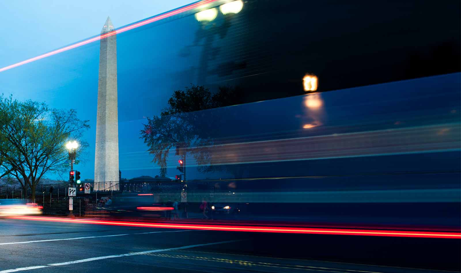 Blurred bus driving past the Washington Monument